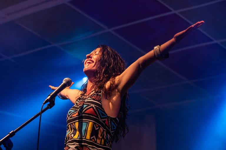Female singer with arms raised